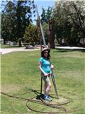 Posing with a giant needle at Parque De Las Esculturas (sculpture park)
