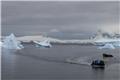 Zodiac amid the icebergs by Cuverville Island